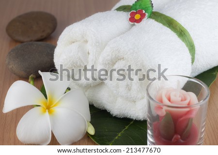 white towels roll on wooden background