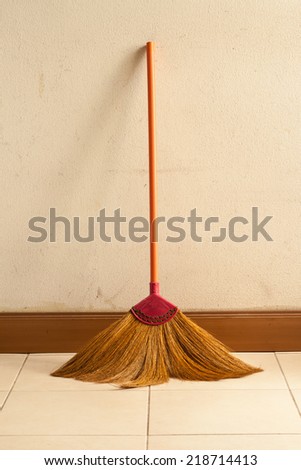 Old obsolete broom or besom leaning on the wall