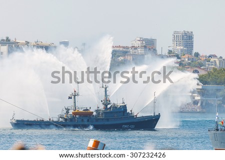 Crimea - 26 July 2015: parade in honor of the Day Russian Navy in Sevastopol. Fire ships show a beautiful fountain
