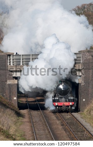 November 2012 Former Southern Railway King Arthur class locomotive 30777 'Sir Lamiel' bursts under the A6 bridge as it approaches Woodhouse on the Great Central with the 1130 service from Loughborough