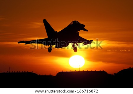 December 2013. First Tranche 3 Eurofighter Typhoon flies; Seen here is late production Tranche 2 aircraft flying with No 29 Squadron. Landing at RAF Coningsby against a setting sun in silhouette