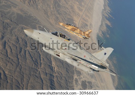 February 2009. A pair of Royal Air Force of Oman BAE Systems Hawk jet fighters over Masirah Island marking the air force 50th anniversary.
