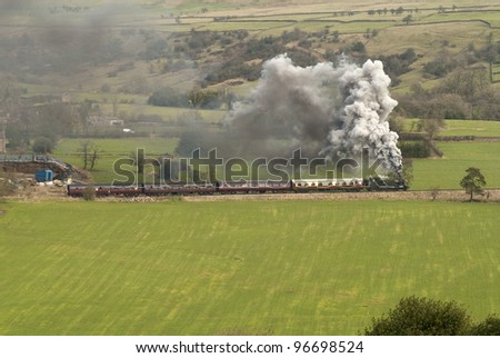 February 2012. Former Great Western Railway Prairie tank engine Climbing hard up to the summit between Leekbrook Junction and Cauldon Lowe in Staffordshire, England. Lots of smoke and green fields.
