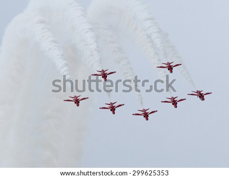 July 2015. Royal International Air Tattoo, RAF Fairford, UK, British Aerospace Hawk jet trainers of the Red Arrows display to thrill the crowds and are seen coming out of a loop.