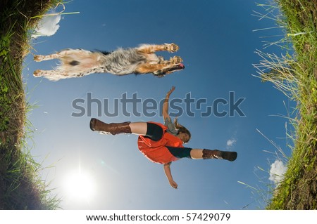 stock-photo-young-woman-and-her-dog-jumping-over-a-creek-shot-from-below-57429079.jpg