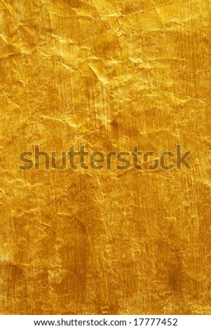 Golden color painted crinkled paper as background