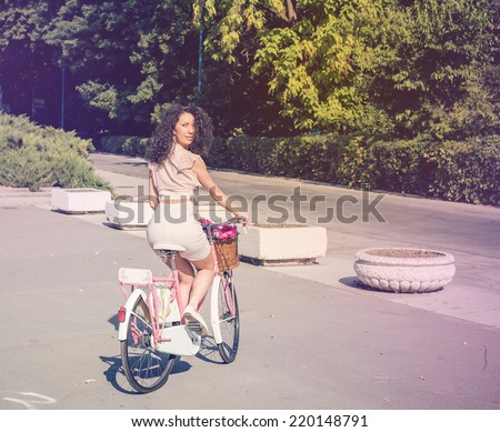 Young pretty beautiful woman riding her white retro hipster bike,wearing stylish vintage clothes, fashion fall autumn portrait of elegant lady having fun outdoor.