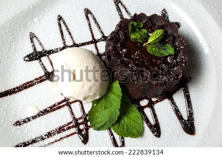 Vanilla ice cream Brownie with mint and whipping cream in dish on table