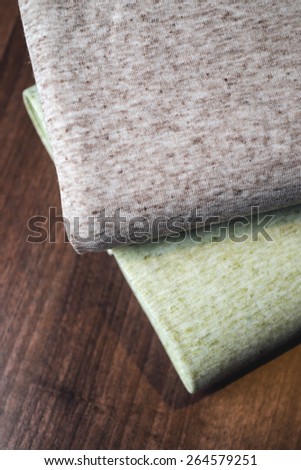 Rolls of fabric on wooden background.