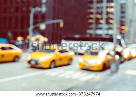 Blurred picture of yellow taxies on Manhattan streets