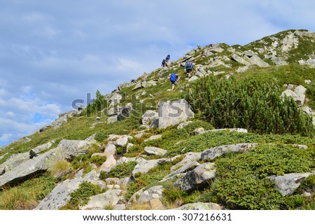 Group of Tourists Climbing High in The Mountain