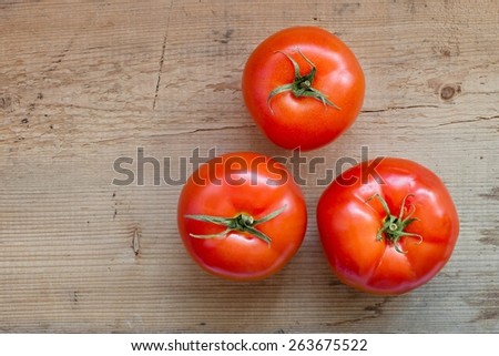 Fresh tomatoes on wooden background, from above