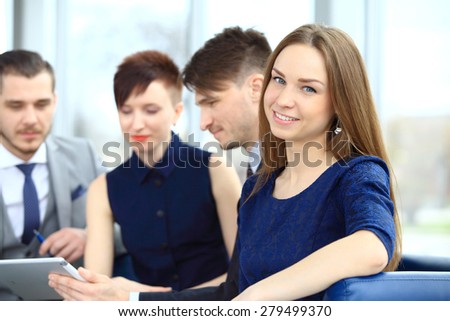 Business people with smiling female leader in foreground