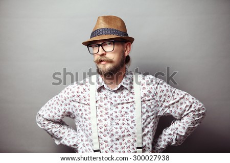 Portrait of young hipster with arms akimbo