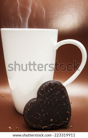 Cup mug white big hot baking gingerbread cookies on a brown background