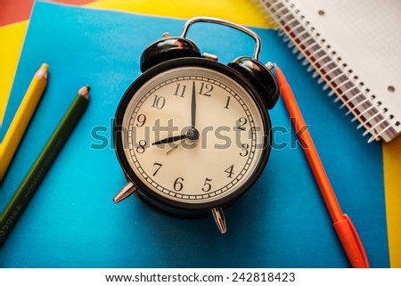 service time watch clock dial pencil pen colored paper address book notebook colored pencils blue red yellow white spiral morning lesson lecture break waiting