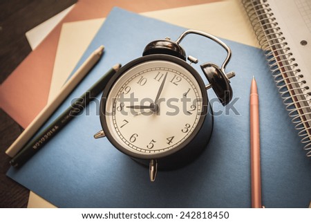 service time watch clock dial pencil pen colored paper address book notebook colored pencils blue red yellow white spiral morning lesson lecture break waiting