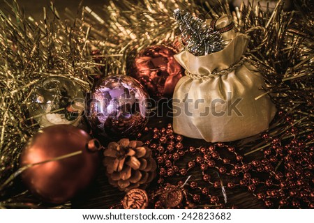 bag sack gift ball present spruce fir Christmas toy tinsel red purple golden gold wooden floor