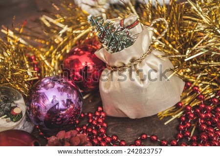 bag sack gift ball present spruce fir Christmas toy tinsel red purple golden gold wooden floor