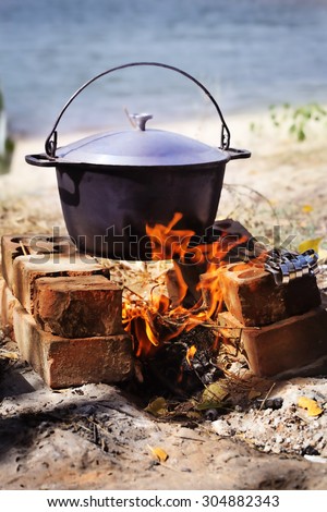 the cauldron on the fire summer riverside the food at the stake