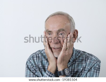 Senior man with head in hands in despair