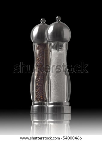 Salt and pepper grinders on black