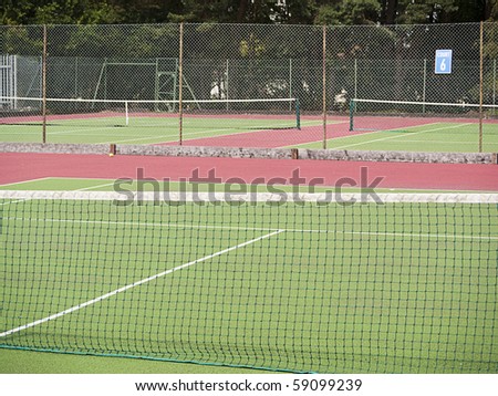 Empty tennis courts with hard surface