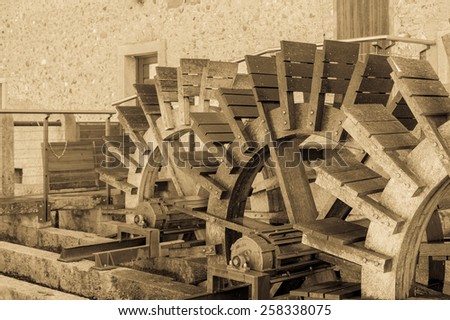 Effect vintage.Series of three wheeled wooden mill renovated
