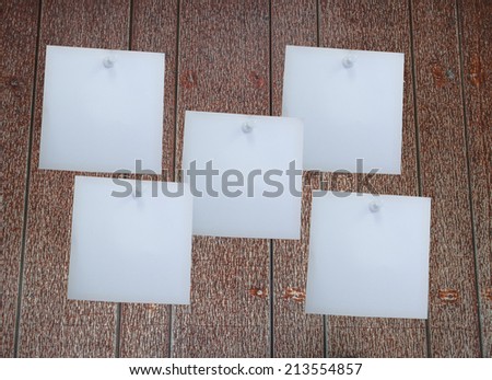White blank paper attached with blue, white, yellow pin
