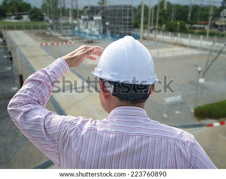 Young engineer looking work in front of construction site