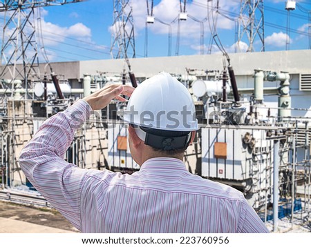 Young engineer looking work in front of substation
