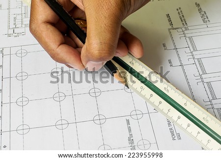 Design drawings and human hands drawing a project by pencil on paper