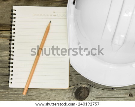 Architectural blueprint of office building with a pencil,notebook on wood table