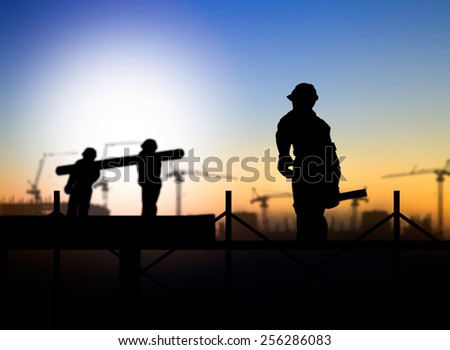 silhouette engineer looking  a building site over Blurred construction worker on construction site