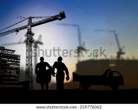 silhouette man engineer looking at blueprints in a building site over Blurred construction