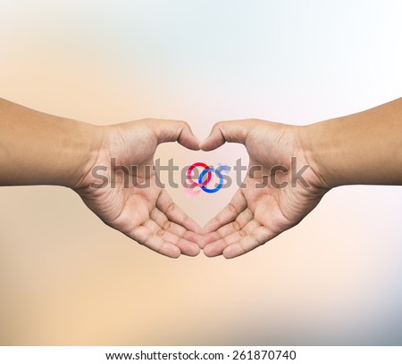 Human hand holding Mars Venus or Male Female symbol. Safe Sex concept.