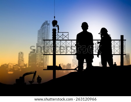 silhouette man engineer looking blueprint in a building site over Blurred construction worker on construction site
