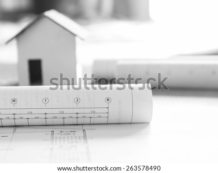 Architectural blueprint for construction over blurred home model