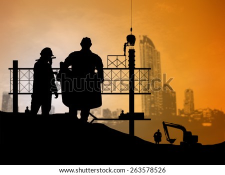 silhouette man engineer looking blueprint in a building site over Blurred construction worker on construction site