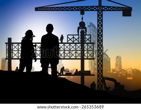 silhouette engineer looking construction worker in a building site over Blurred construction site