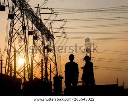 silhouette man engineer looking construction site over Blurred substation