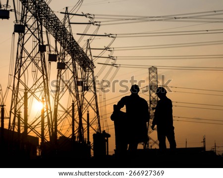 silhouette engineer looking construction site over Blurred substation
