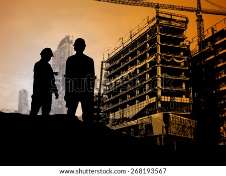 silhouette engineer looking blueprint in a building site over Blurred construction site