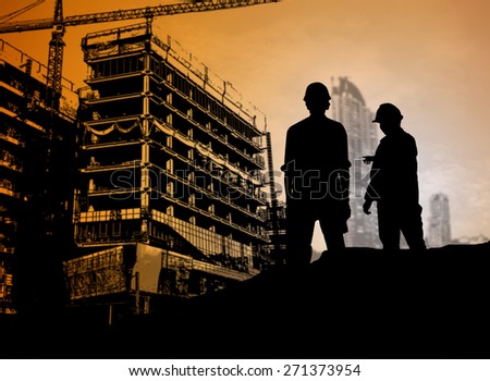 silhouette man engineer looking blueprint in a building site over Blurred construction site