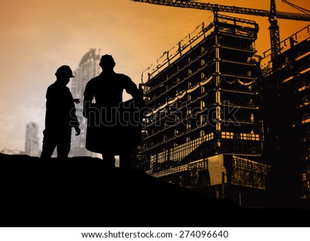 silhouette engineer looking blueprint in a building site over Blurred construction site