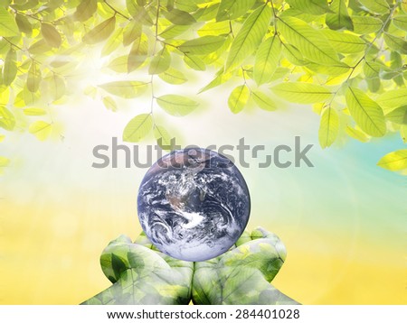 Planet in human hands over blurred nature background. environment concept. Elements of this image furnished by NASA.