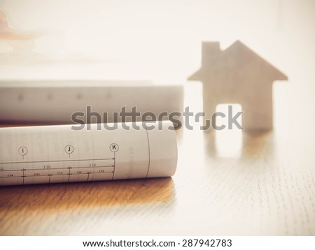 Architectural blueprint of office building over blurred model Home