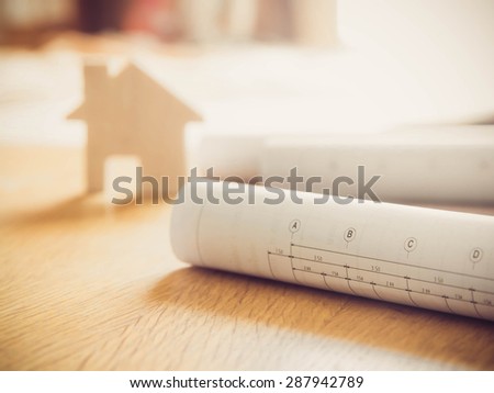 Architectural blueprint of office building over blurred model Home