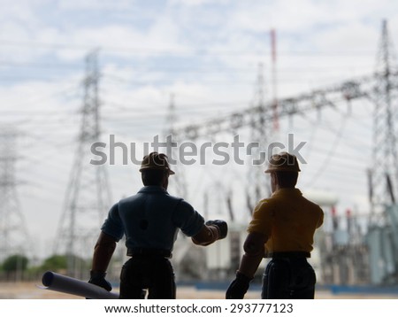 silhouette of engineers over blurred standing at electricity station