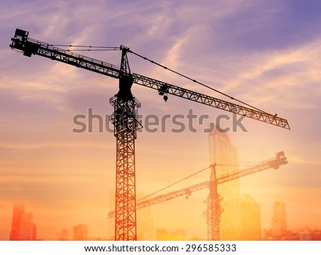 Silhouette Tower cranes used in heavy industry. Construction Concept.